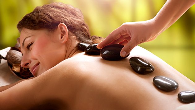 Le massage du dos avec des pierres chaudes